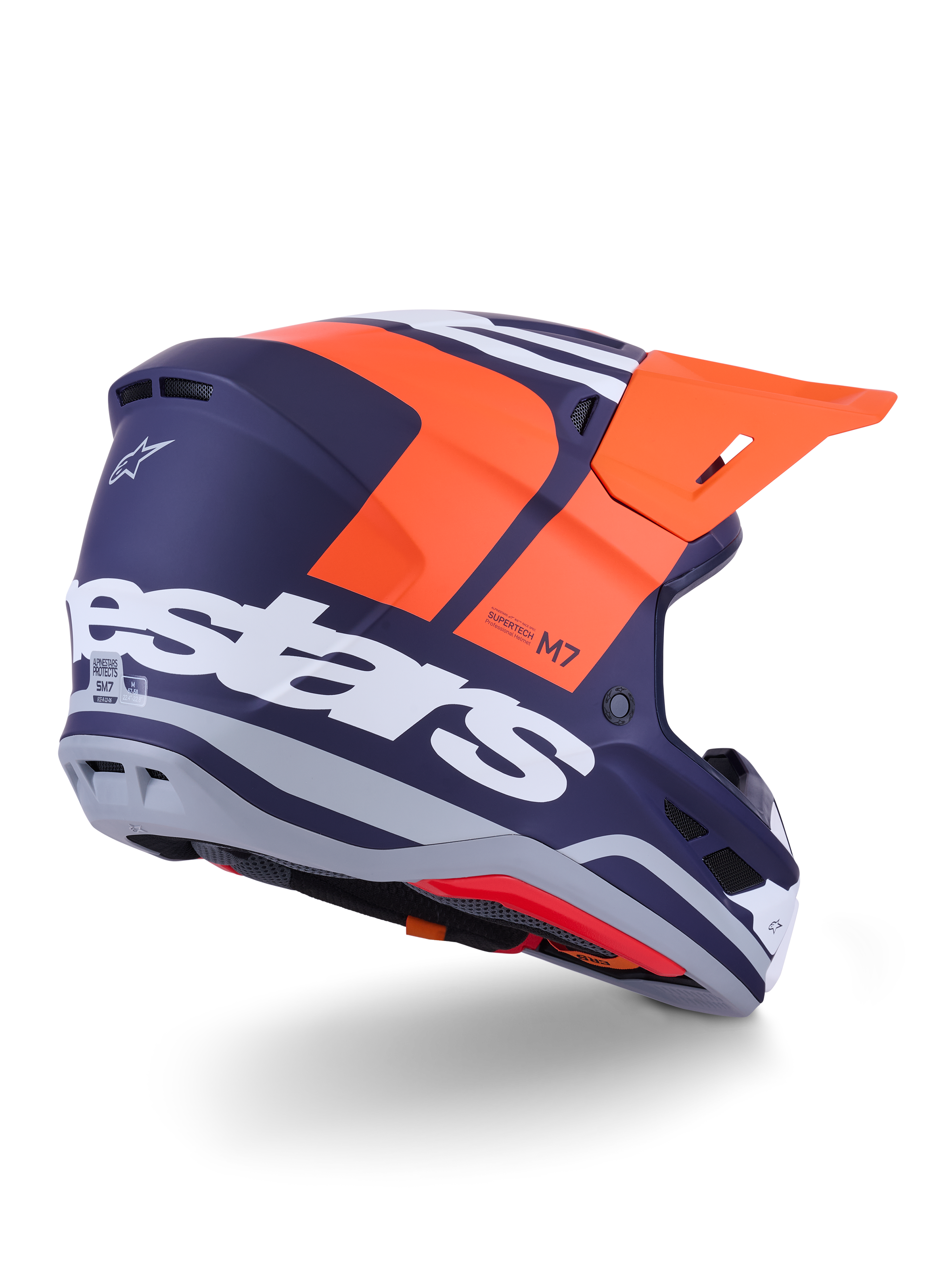 Alpinestars S-M7 Core hjelm, motocross-hjelm, mat orange og blå, set bagfra fra siden med markant hvidt Alpinestars-branding på bagsiden, stærk orange visir, aerodynamisk kompositskal med grå detaljer, professionel beskyttelse til off-road racing
