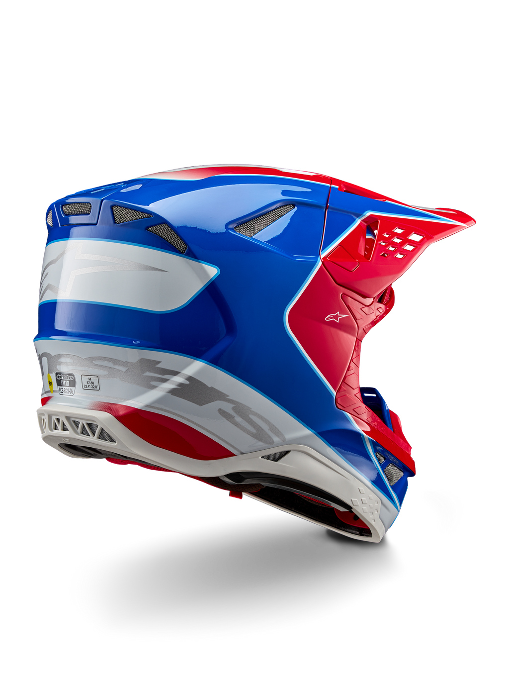 Alpinestars Supertech M10 Aeon ECE 22.06 hjelm, motocrosshjelm, klar rød, blå og hvid blank, set skråt bagfra med aerodynamisk profil, sølvfarvet Alpinestars-branding og integrerede ventilationsporte.