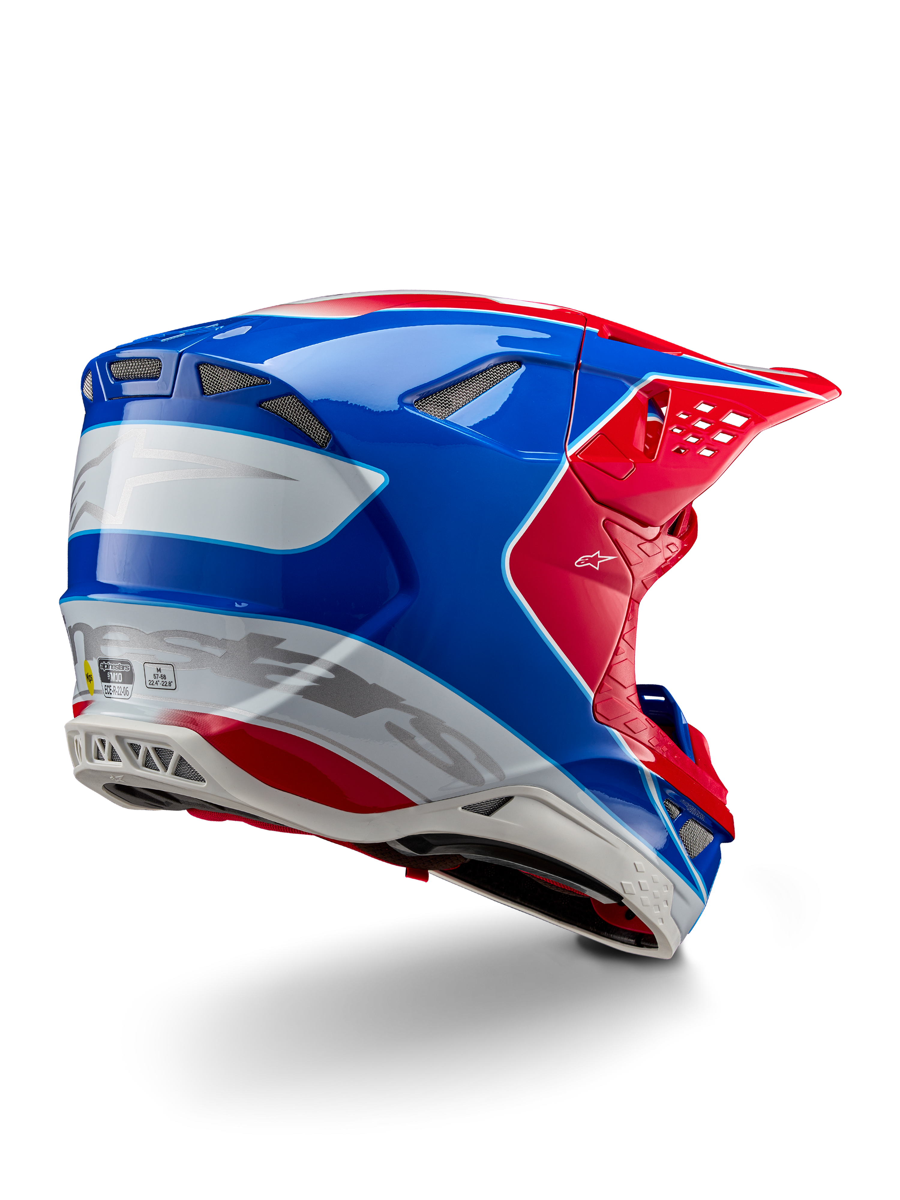 Alpinestars Supertech M10 Aeon ECE 22.06 hjelm, motocrosshjelm, klar rød, blå og hvid blank, set skråt bagfra med aerodynamisk profil, sølvfarvet Alpinestars-branding og integrerede ventilationsporte.