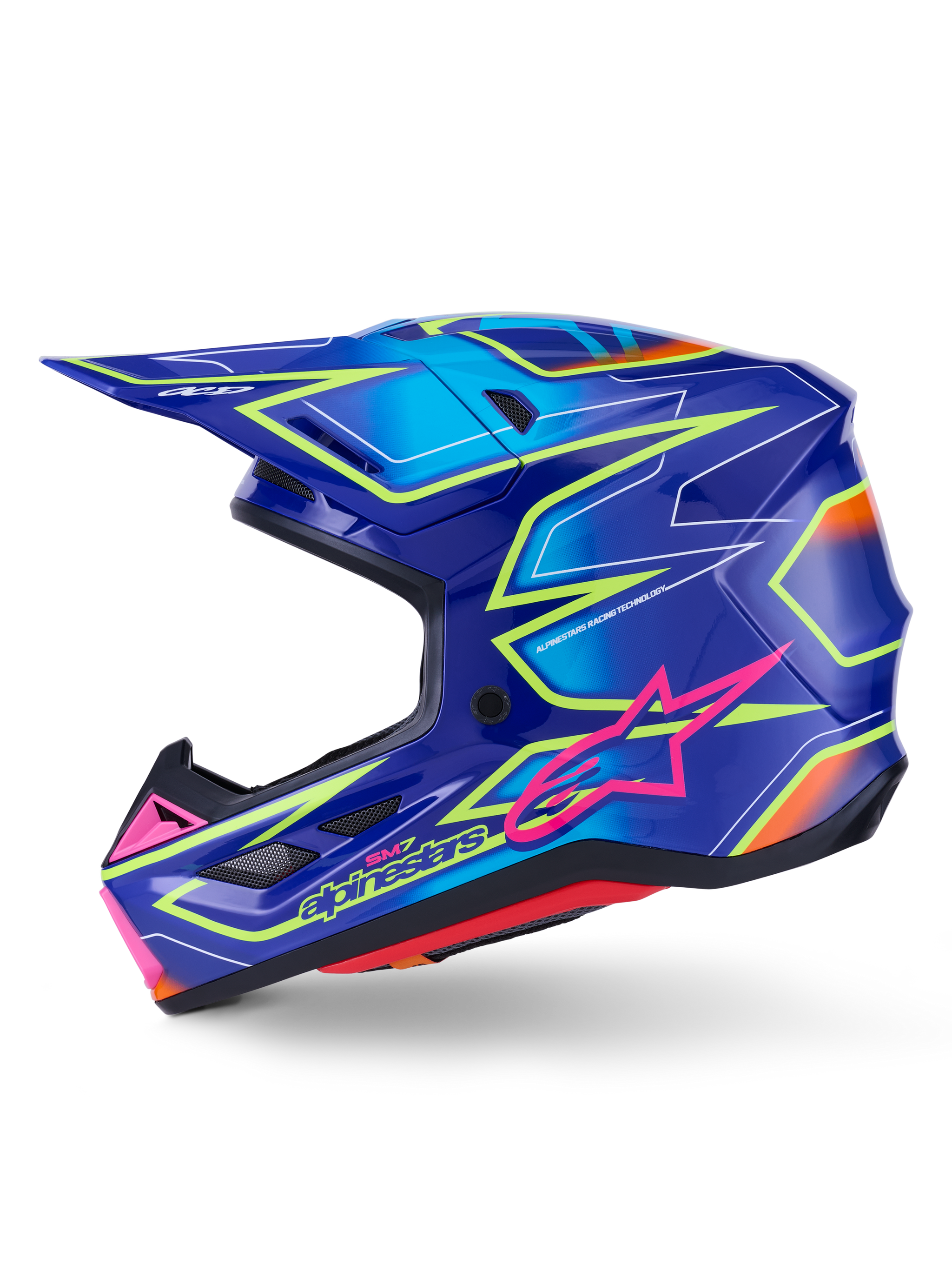 Alpinestars S-M7 Cast-hjelm, motocross-hjelm, blå med pink og gule fluo-blanke detaljer, sideprofilvisning, der viser den aerodynamiske kompositskal, integrerede ventilationsåbninger, pink stjernelogo og gul branding, designet til beskyttelse ved off-road racing.