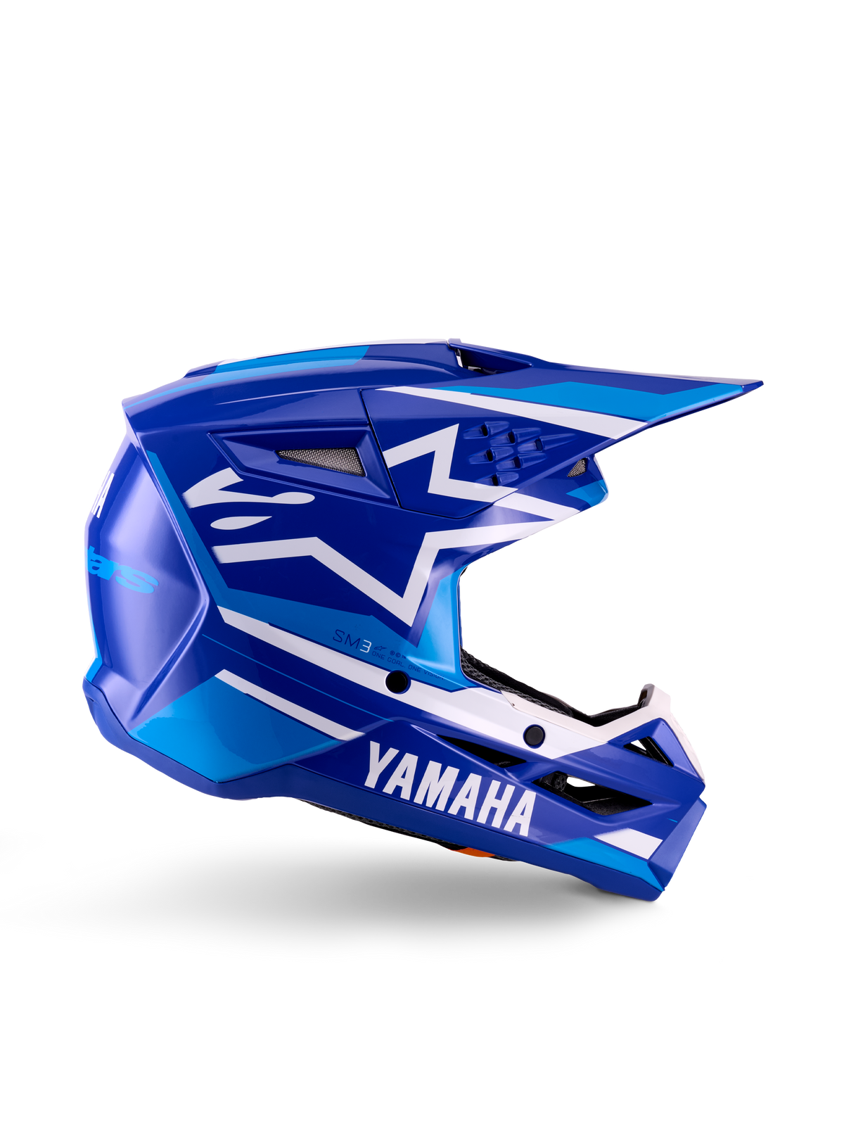Yamaha S-M3 motocrosshjelm til unge, blå og hvid blank, sideprofil med markant Yamaha-branding og Alpinestars-stjernelogo, geometrisk design med lyseblå detaljer, ventileret skal med langt visir, ECE 22.06-certificeret off-road hovedbeskyttelse