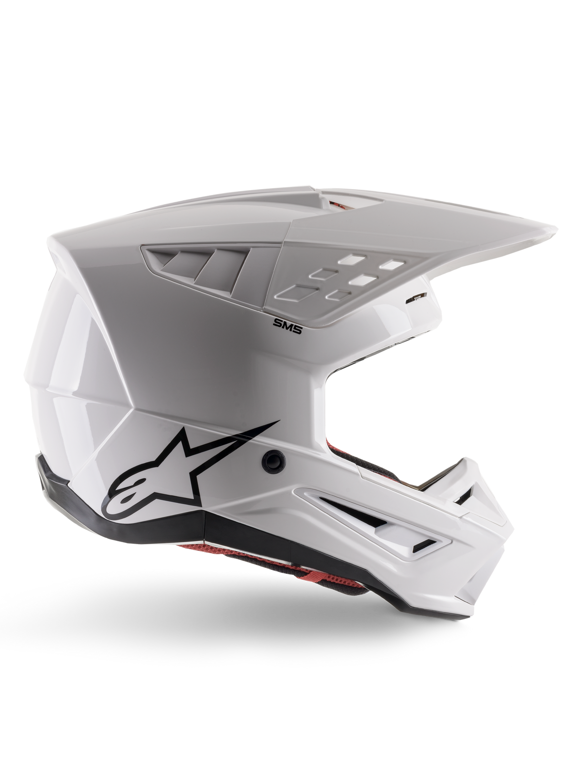 Alpinestars S-M5 Solid-hjelm ECE 22.06, motocross-hjelm, blank hvid, sideprofil med et kantet aerodynamisk design, fremtrædende skygge, integrerede luftventiler, sort Astars-logo bagpå og synlig rød indvendig polstring