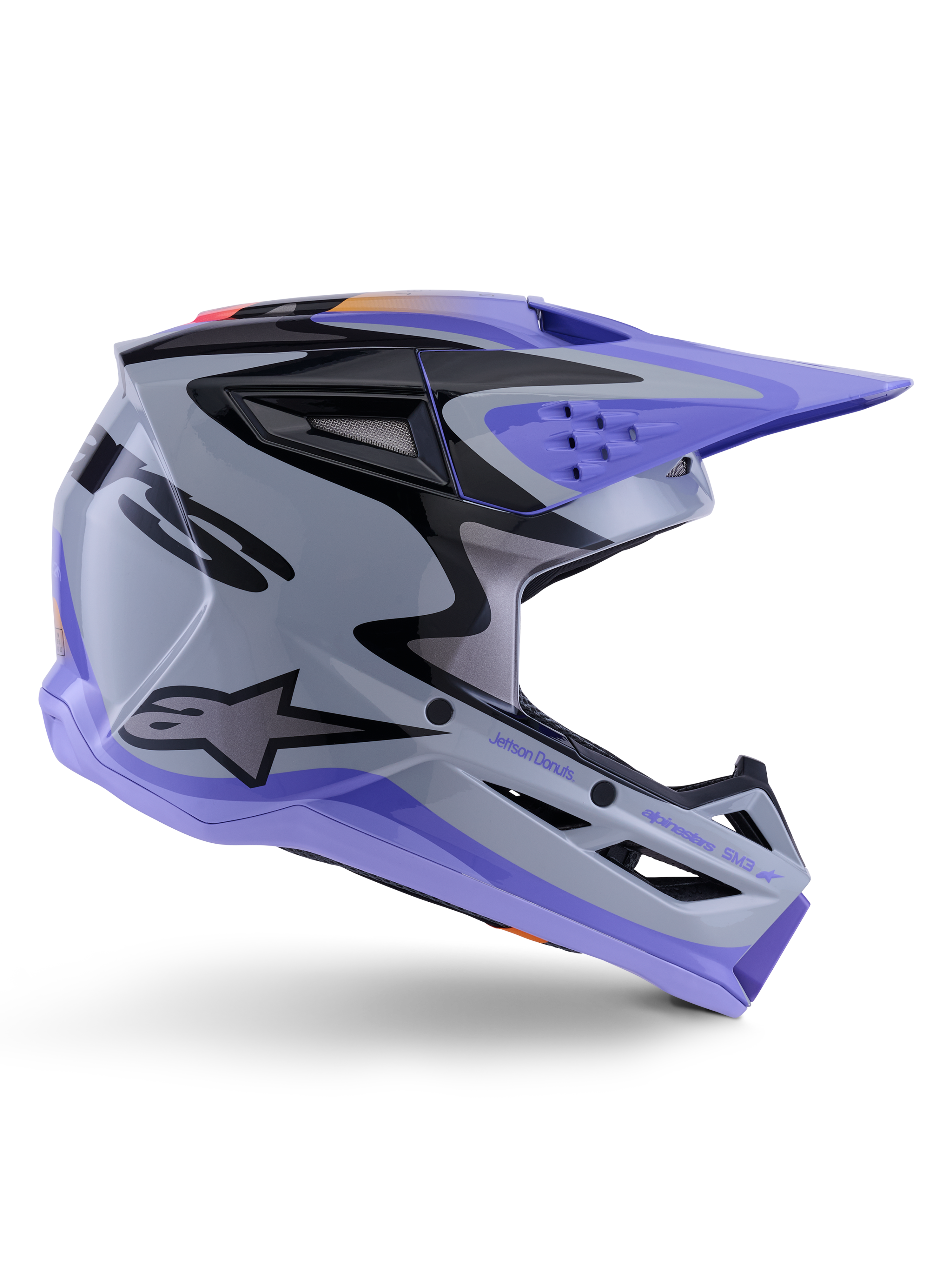 Alpinestars S-M3 Jettson ungdomshjelm, motocross-hjelm, grå, lilla og sort i blank finish, sideprofil med skarp, kantet grafik og 'Jettson Donuts'-branding, aerodynamisk skaldesign med ventilationsporte og Alpinestars-logo, højtydende terrængående beskyttelsesudstyr til unge
