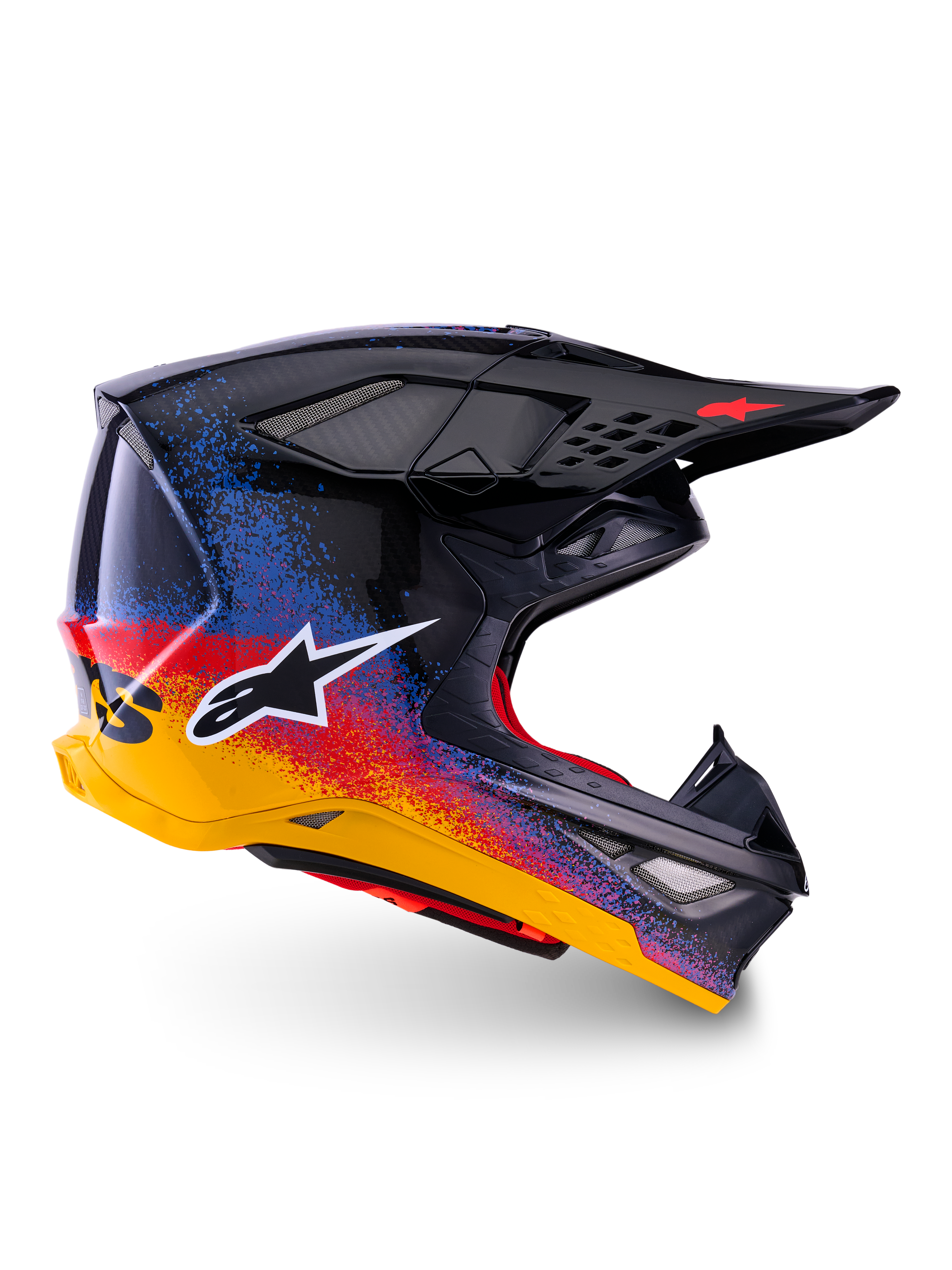 Alpinestars Limited Edition Supertech M10 Black Hole Helmet, Motocross Racing Helmet, Black shell with red, blue, and yellow gradient splatter design, white star logo on side, aerodynamic profile with mesh-covered ventilation ports, red interior padding, and long black visor.