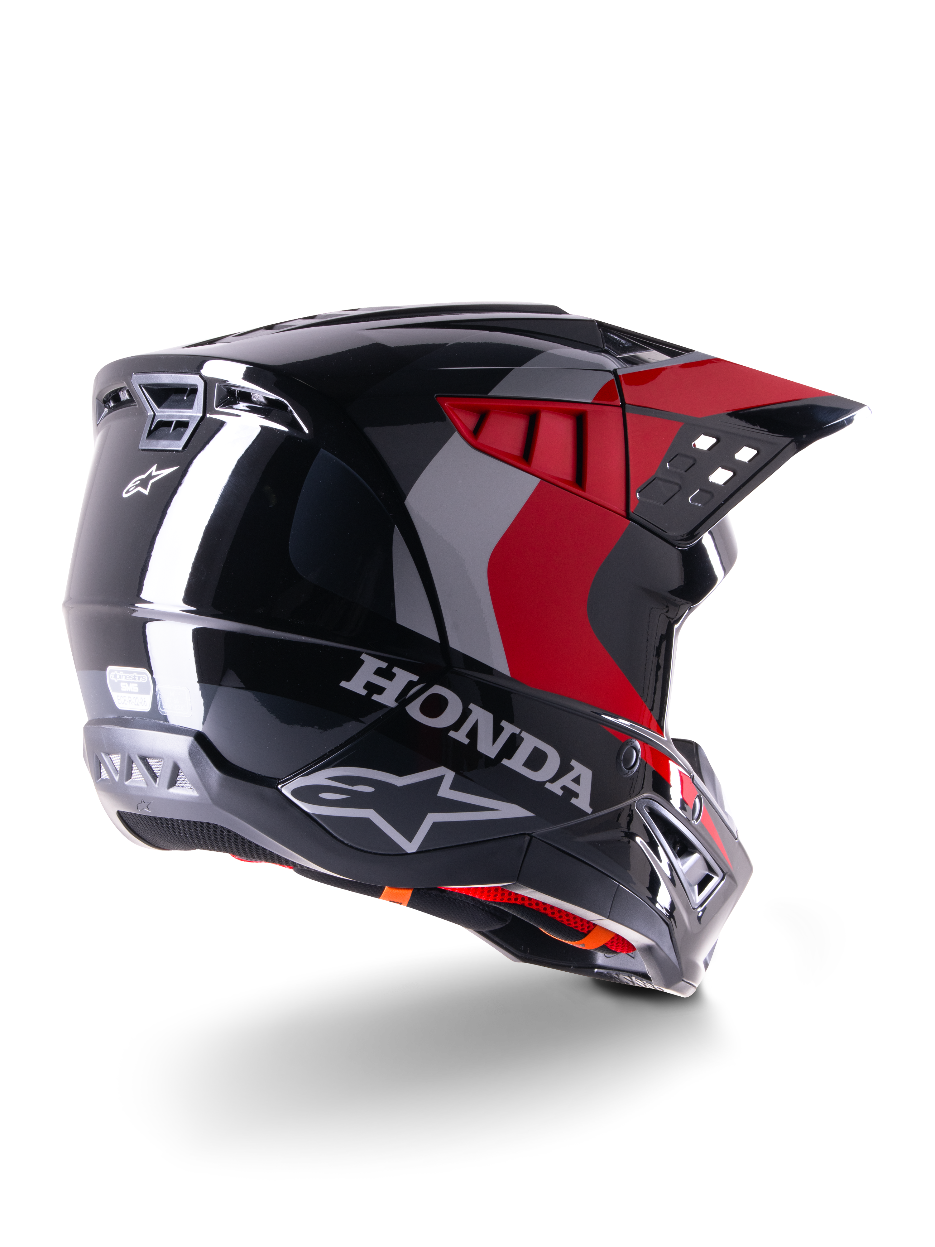 Alpinestars Honda S-M5 ECE-hjelm, motocross-hjelm, blank sort og rød, trekvartvisning bagfra med Honda-branding og Alpinestars-logoer, blank finish med røde og grå grafiske detaljer, designet til off-road-beskyttelse