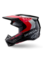 Alpinestars Honda S-M5 hjelm, motocross-hjelm, blank sort, rød og sølv, set fra siden med Honda-branding og Alpinestars stjernelogo, strømlinet design med integreret skygge og ventilationsporte til terrænkørsel