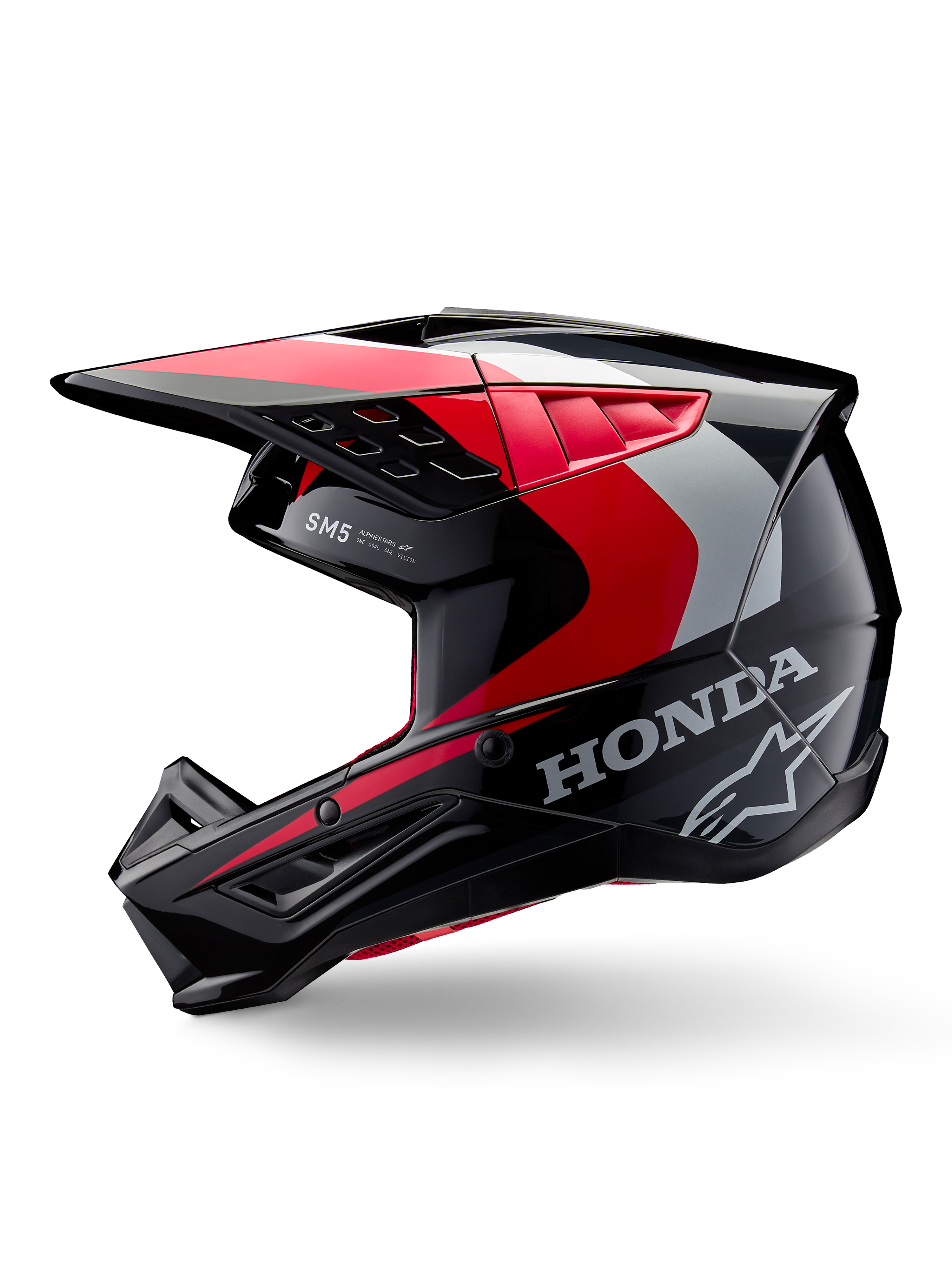 Alpinestars Honda S-M5 hjelm, motocross-hjelm, blank sort, rød og sølv, set fra siden med Honda-branding og Alpinestars stjernelogo, strømlinet design med integreret skygge og ventilationsporte til terrænkørsel