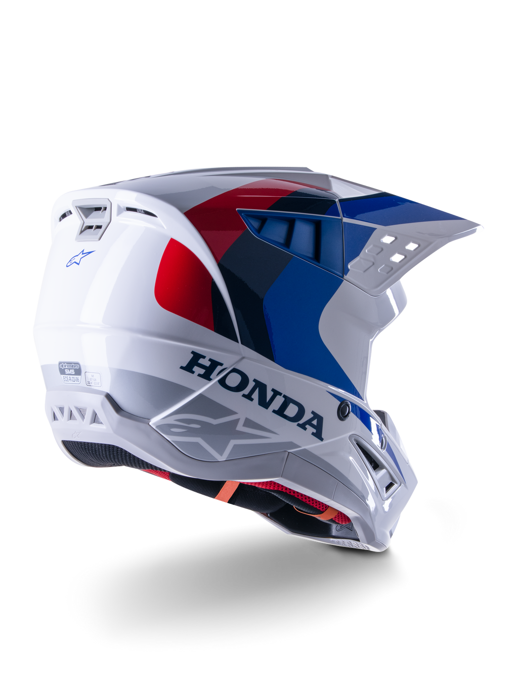 Alpinestars Honda S-M5 ECE hjelm, motocrosshjelm, hvid, blå og rød blank, med markant Honda-branding og Alpinestars-logoer, aerodynamisk skal med integrerede ventilationsåbninger og justerbart visir, beskyttelsesudstyr til terrænkørsel