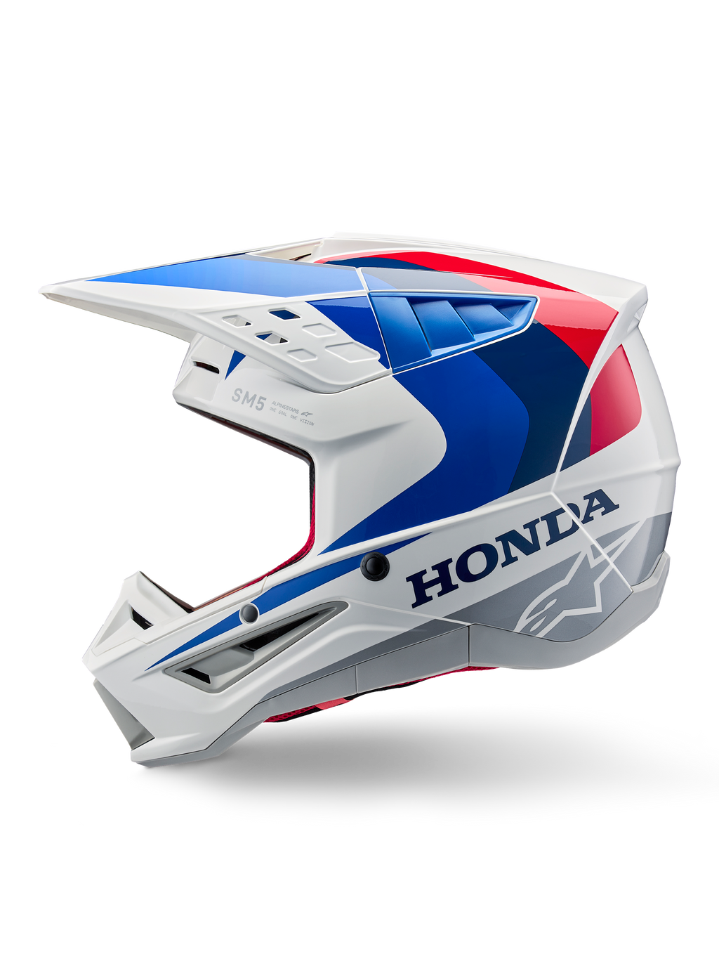 Alpinestars Honda S-M5 hjelm ECE, hvid blå rød blank, set fra siden, med tydelig Honda-branding og Alpinestars stjernelogo, aerodynamisk motocross-design med flere ventilationsåbninger og en markant skygge, blank finish