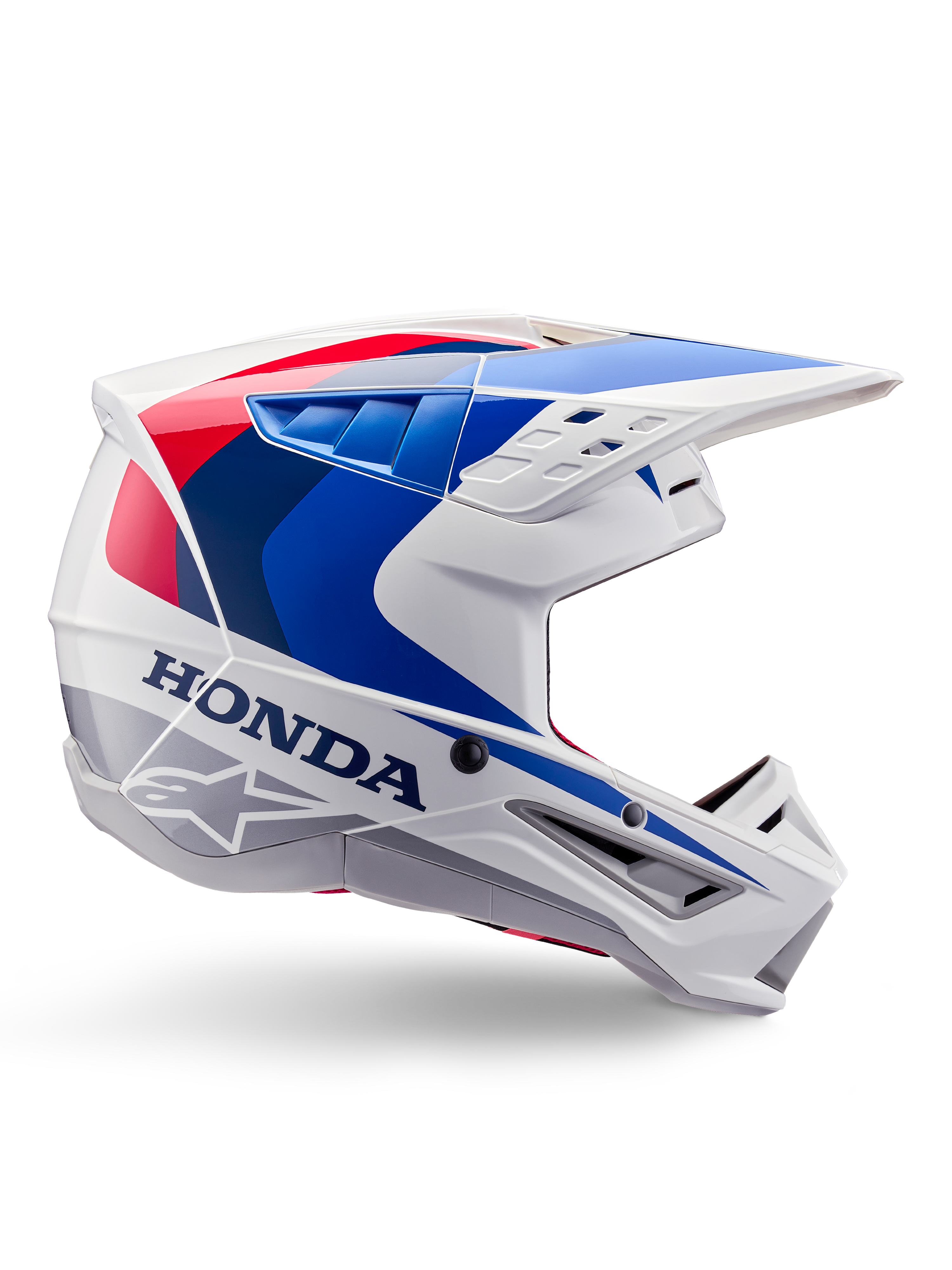 Alpinestars Honda S-M5 hjelm ECE, motocross-hjelm, hvid, blå og rød, sideprofil, aerodynamisk design med integreret visir, flere ventilationsåbninger, blank finish, tydelig Honda-branding og Alpinestars-logo