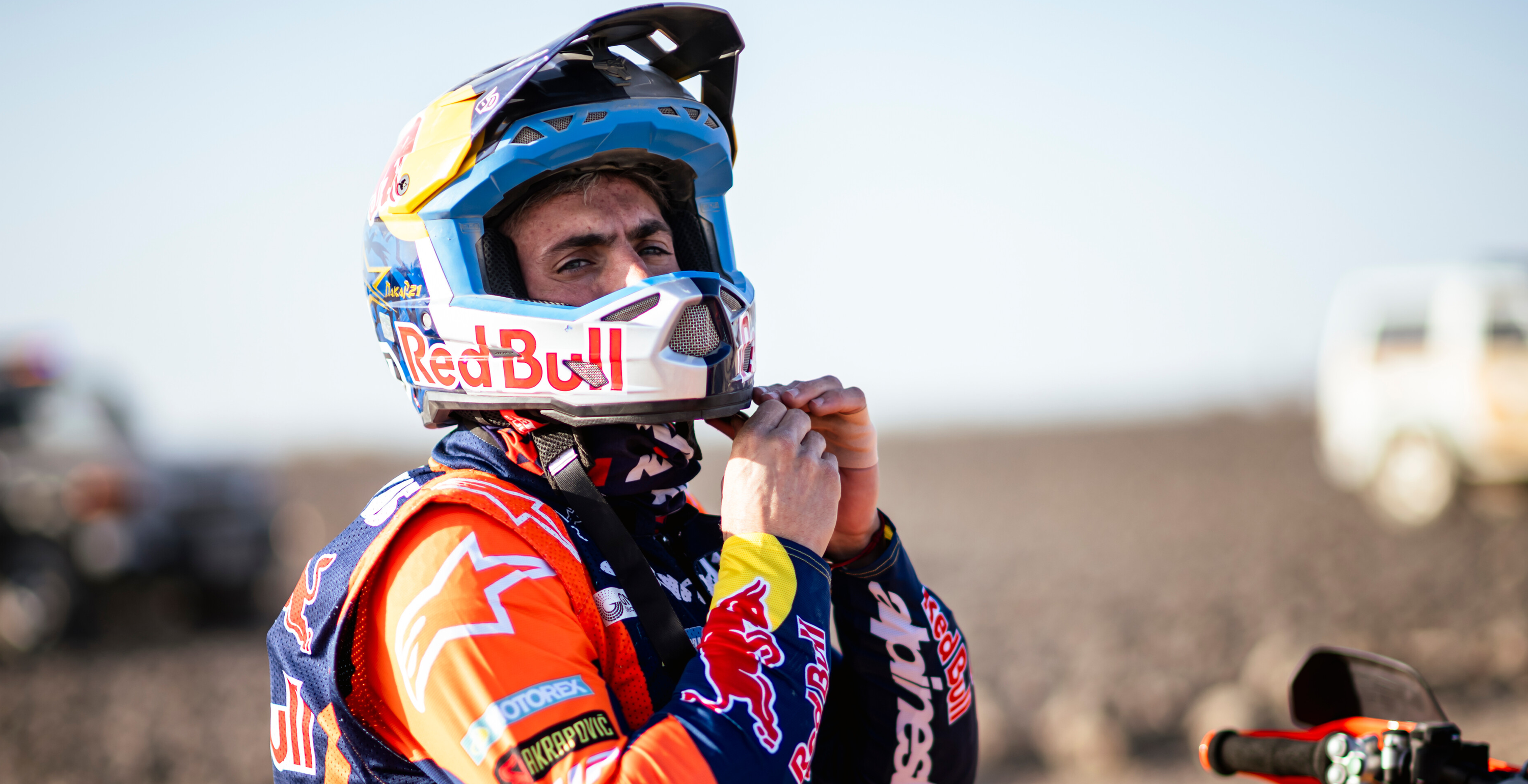 Kevin Benavides wearing a Red Bull helmet and enduro Alpinestars jacket in an outdoor setting