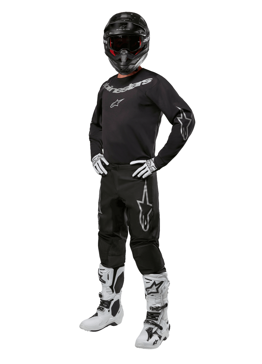 Alpinestars 2024 Fluid Graphite-udstyrssæt, komplet motocross-raceroutfit, sort med grå og hvide logoer, bestående af trøje og bukser båret med matchende sort hjelm, hvide og sorte handsker og støvler, designet til off-road beskyttelse