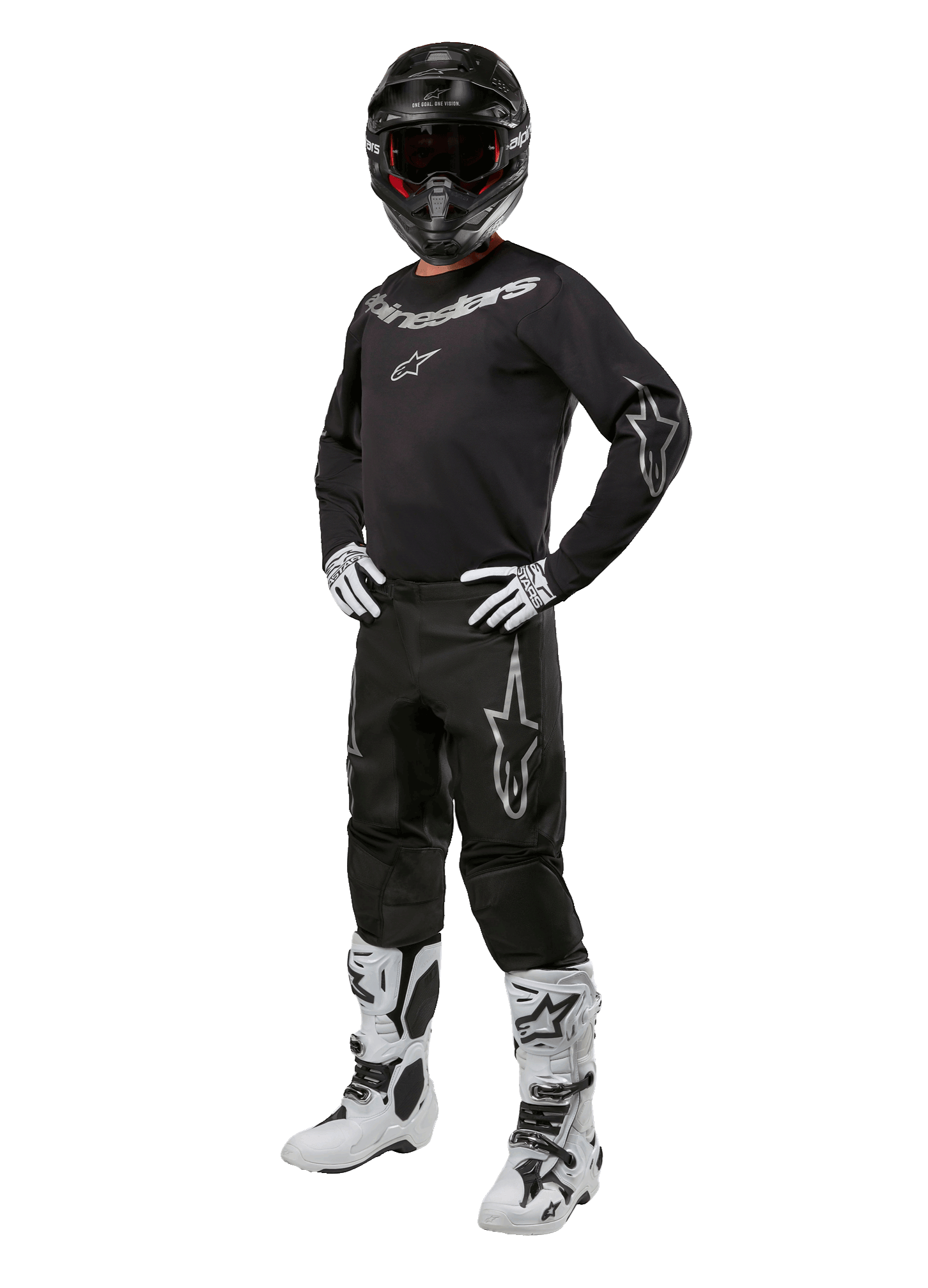 Alpinestars 2024 Fluid Graphite-udstyrssæt, komplet motocross-raceroutfit, sort med grå og hvide logoer, bestående af trøje og bukser båret med matchende sort hjelm, hvide og sorte handsker og støvler, designet til off-road beskyttelse