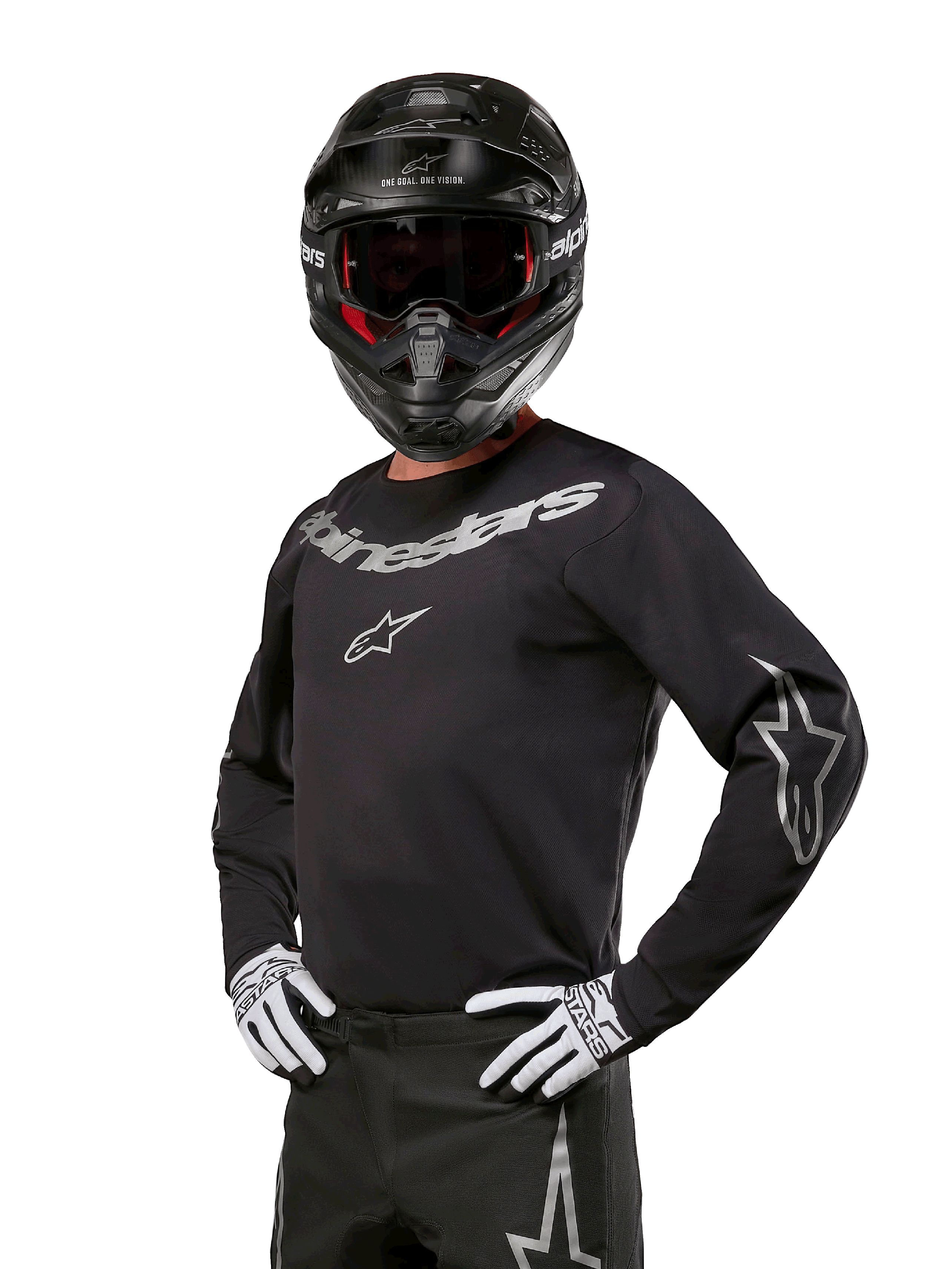 Alpinestars 2024 Fluid Graphite Gearsæt, motocross-kører iført sort og grå jersey med markante grå logoer, matchende bukser, sort hjelm og hvid-sorte handsker, atletisk sportspasform til off-road motocross-racing