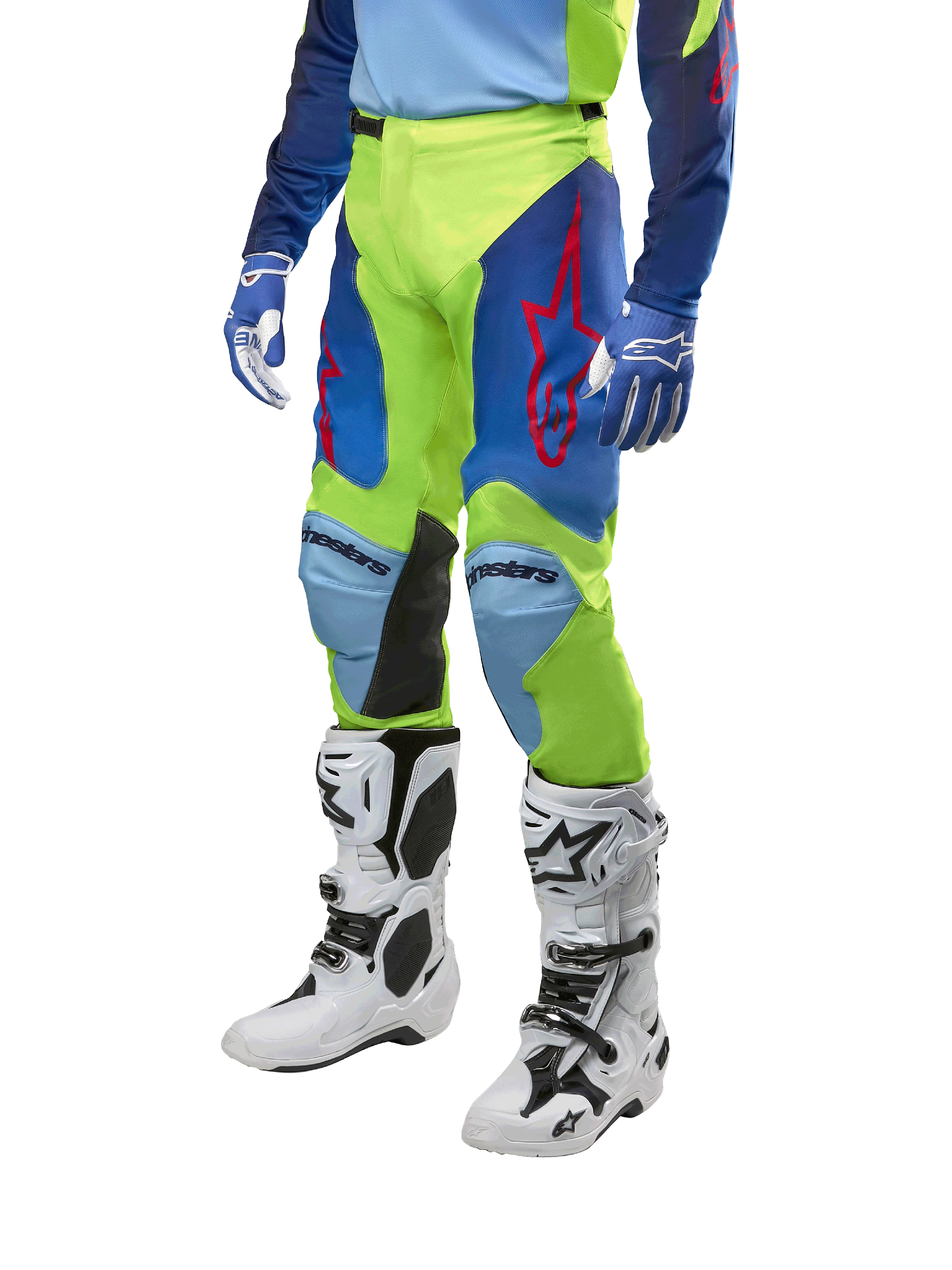 Alpinestars 2024 Racer Hoen bukser, motocross-bukser, gul fluo og mørkeblå, med røde stjernelogoer og sorte indvendige knæpaneler, båret med en matchende trøje og hvide motocross-støvler, performance-udstyr til off-road kørsel