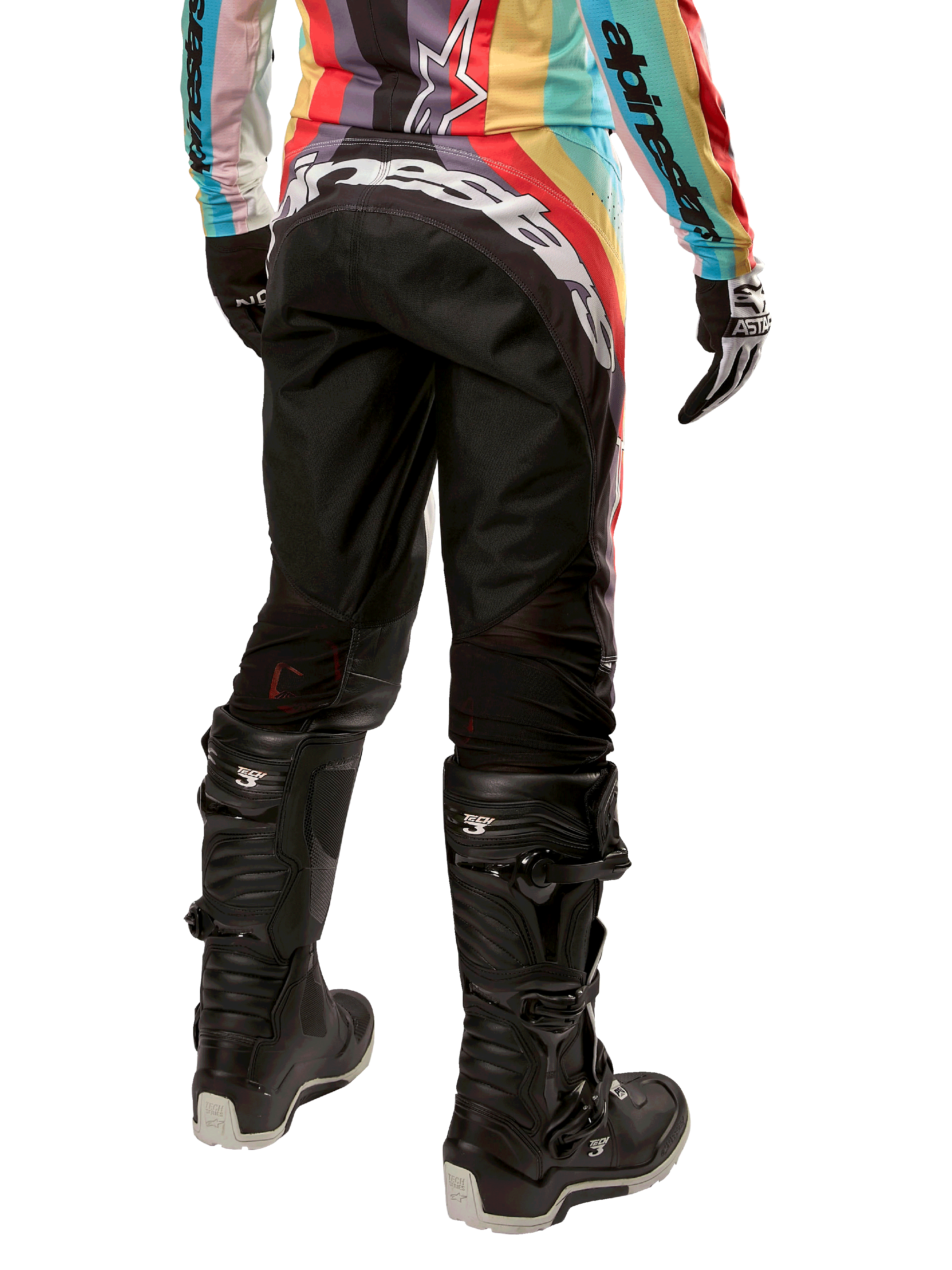 Alpinestars Stella 2024 Techstar bukser, motocross-bukser til damer, sort multifarvet, set bagfra med markant hvidt logo over bagen, båret med sorte Tech 3-støvler og matchende multifarvet jersey, professionelt off-road racerudstyr