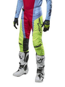 Alpinestars 2024 Techstar Ocuri Pants, Motocross Pants, Light Blue, Red Berry, and Neon Yellow, worn with matching gear and white boots, featuring bold Astars branding and a performance racing fit.