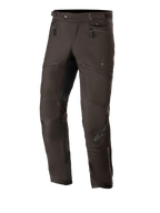 Alpinestars AST-1 V2 Waterproof Pants Long, Black Motorcycle Touring Pants, featuring zippered hip pockets and adjustable waist straps, pre-curved legs with reinforced knee panels, subtle grey logo on the shin, durable textile construction for all-weather road use