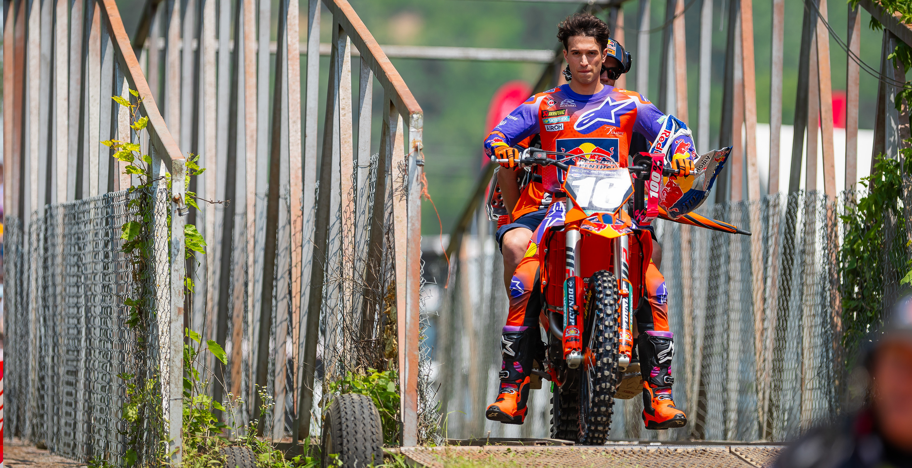 Tom Vialle in colorful Alpinestars motocross gear on a dirt bike, with a blurred background