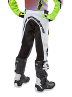 Alpinestars Youth 2024 Racer Lucent Pants, Motocross Pants, White and Black with Neon accents, back view showing large rear stretch panel and Alpinestars logo, worn with black and white Alpinestars Tech Series boots.