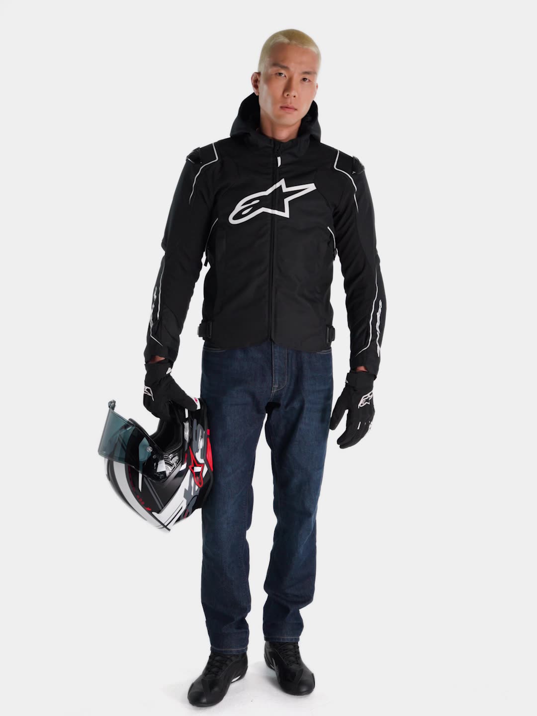 Alpinestars Zaca V2 Waterproof Jacket, men's textile motorcycle racing jacket in black and white, worn by a model showcasing waterproof construction and protective features.